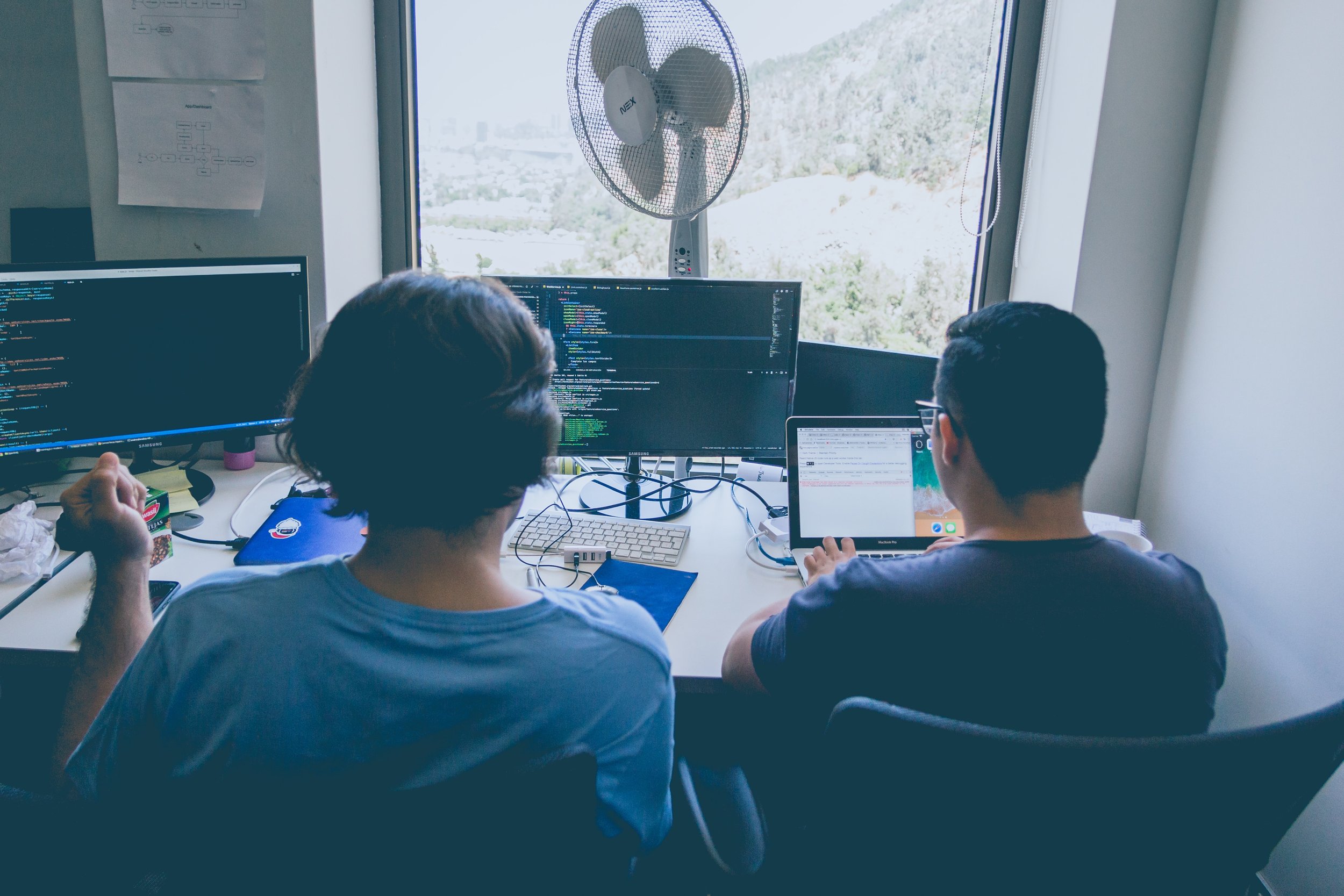 Working in a hot office with a fan to keep cool.