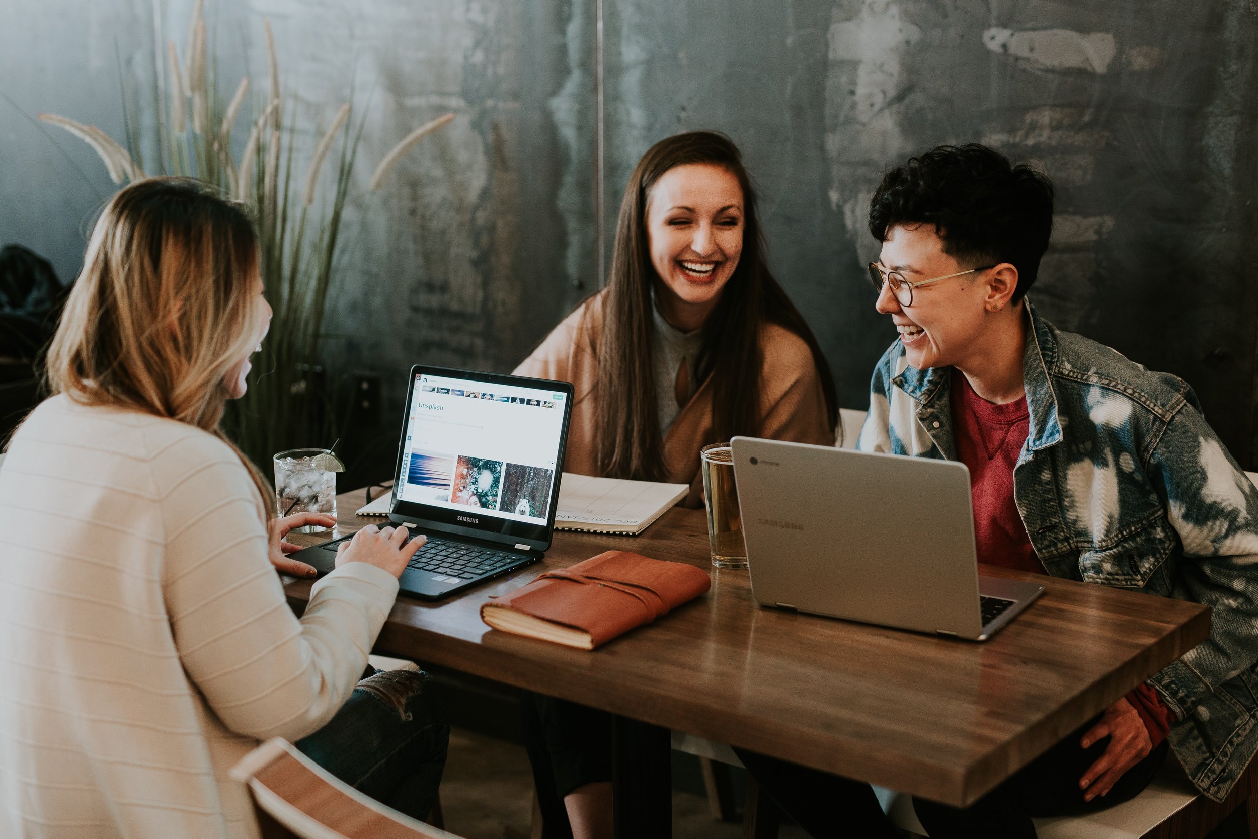 A group of female entrepreneurs doing their best work in a co-working space.